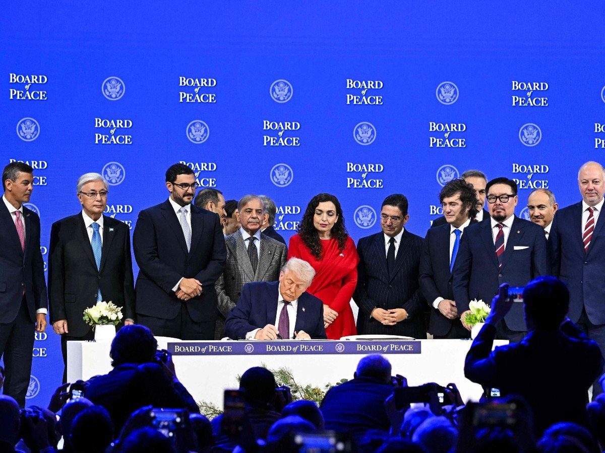 Paraguay's President Santiago Pena (L), Prime Minister Shehbaz Sharif (5L), Kosovo's President Vjosa Osmani (C-R), Morocco's Foreign Minister Nasser Bourita (6R), Argentina's President Javier Milei (5R), Armenia's Prime Minister Nikol Pashinyan (2R), Bulgaria's former Prime Minister Rosen Zhelyazkov (R), Turkiye's Foreign Minister Hakan Fidan (4R) pose with US President Donald Trump signing a founding charter at the 