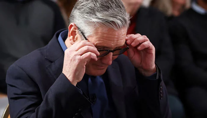 British Prime Minister Keir Starmer adjusts his glasses as he waits to deliver his speech at Horntye Park Sports Complex in St Leonards, Britain, February 05, 2026. — Reuters