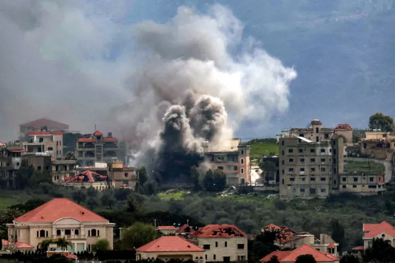 TOPSHOT - Smoke plumes rise following Israeli bombardment on the village of Khiam in southern Lebanon near the border with Israel, as seen from nearby Marjayoun, on March 16, 2026.