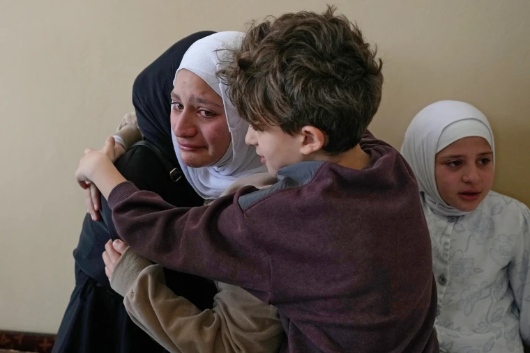 Relatives of Ghadir Baalbaki, 19, who was killed on Tuesday in an Israeli airstrike, mourn during her funeral 