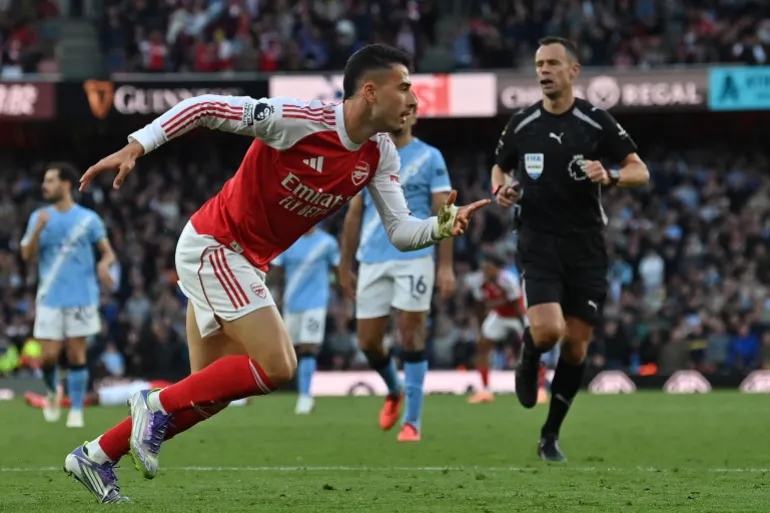 Arsenal's Brazilian midfielder #11 Gabriel Martinelli celebrates after scoring their first goal during the English Premier League football match between Arsenal and Manchester City at the Emirates Stadium in London on September 21, 2025.