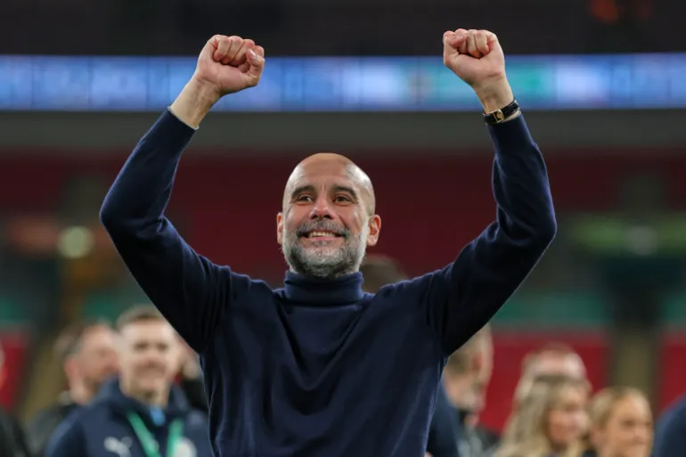 Manchester City's head coach Pep Guardiola celebrates after his team won the English League Cup final soccer match between Arsenal and Manchester City in London, Sunday, March 22, 2026. (AP Photo/Richard Pelham)