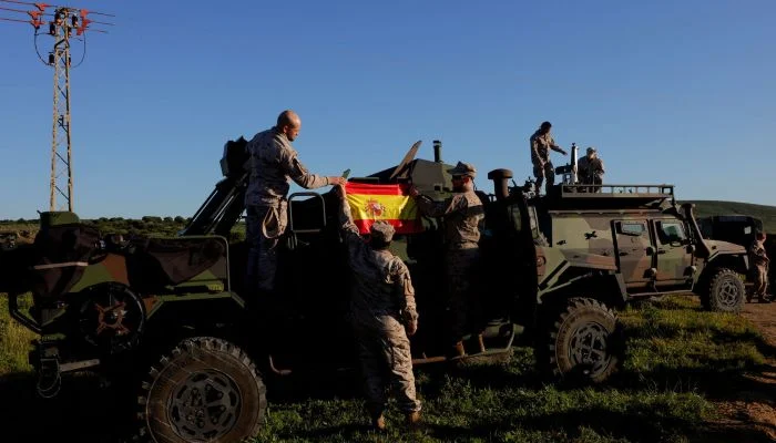 Spanish soldiers place a Spanish flag on a vehicle during Exercise Dynamic Mariner 25 military drill training, which involves naval forces from several Nato members, at Retin beach, in the Atlantic Ocean, in Barbate, Spain, March 28, 2025. — Reuters