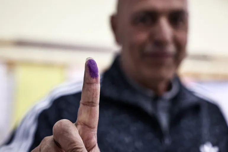 A Palestinian man shows his marked finger after casting his ballot at a polling station during municipal elections in the Israeli-occupied West Bank city of Al-Bireh on April 25, 2026.
