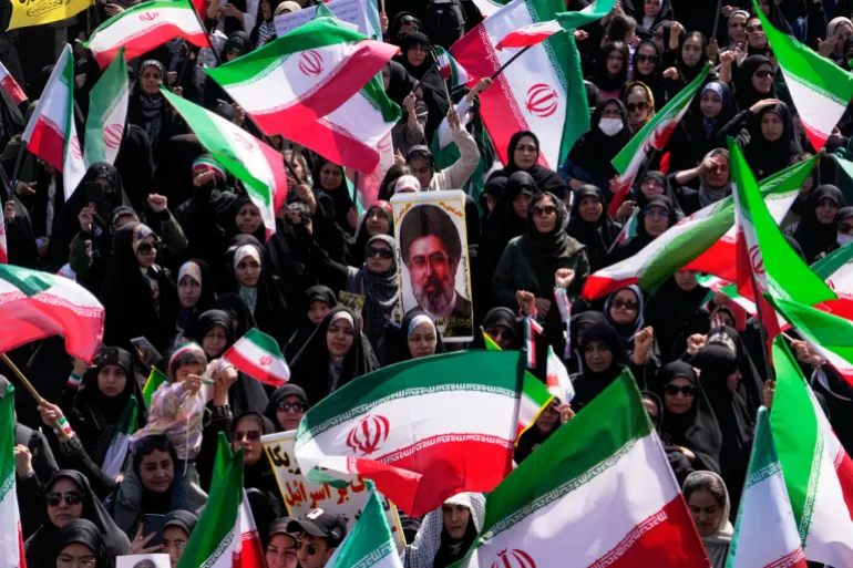Iranian flags with photo of mojtaba