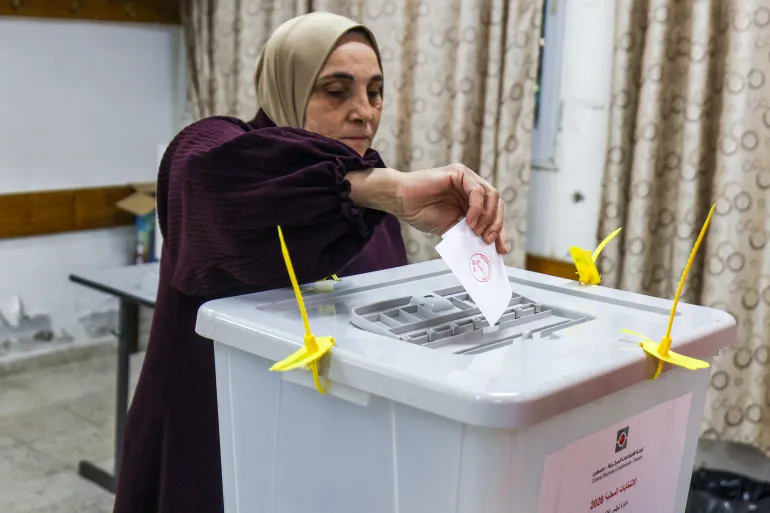 A Palestinian woman casts her ballot at a polling station during municipal elections in the village of al-Badhan, north of Nablus, in the Israeli-occupied West Bank on April 25, 2026.