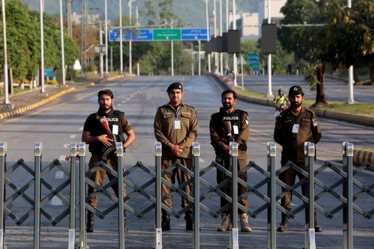 Police officers stand guard behind a barricade near Serena Hotel, as Pakistan prepares to host the U.S. and Iran for the second round of peace talks, in Islamabad, Pakistan, April 25, 2026. REUTERS/Asim Hafeez
