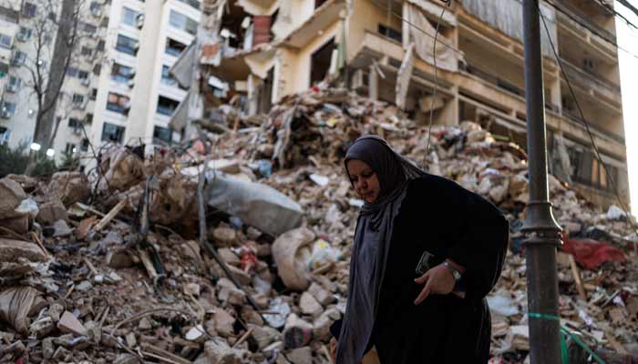 A woman walks past a damaged building at the site of an Israeli strike carried out on April 8, at Corniche al-Mazraa in Beirut, Lebanon April 13, 2026. — Reuters