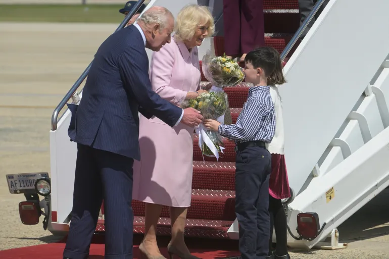 King Charles III and Queen Camilla receive posies from the children of British military families based in the United States, at Joint Base Andrews, Md., Monday, April 27, 2026. They are in the U.S. for a four-day state visit aimed at celebrating the United States' 250th anniversary, including a White House state dinner and a speech to Congress. (AP Photo/Rod Lamkey, Jr.)
