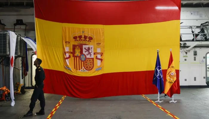 A Spanish Navy soldier stands next to Spanish flags and a Nato flag at the hangar of the Castilla LPD (Landing Platform Dock) type amphibious assault ship, in the Atlantic Ocean, March 28, 2025. — Reuters