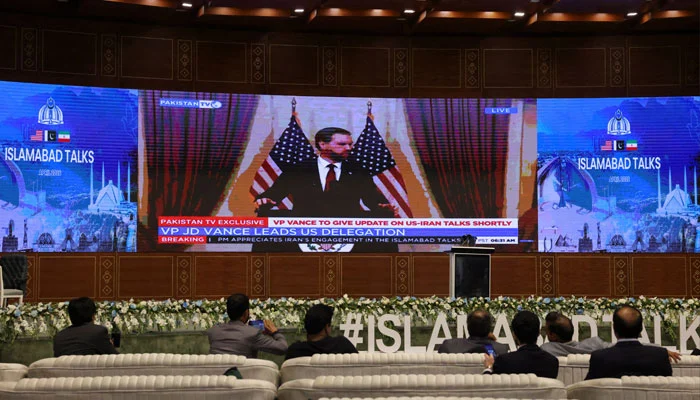 A digital screen displays US Vice President JD Vance addressing a press briefing in Islamabad on April 12, 2026. — Reuters