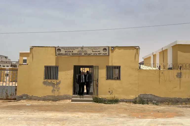 School officials exit the Abdellahi Ould Nouegued public school in Noaukchott