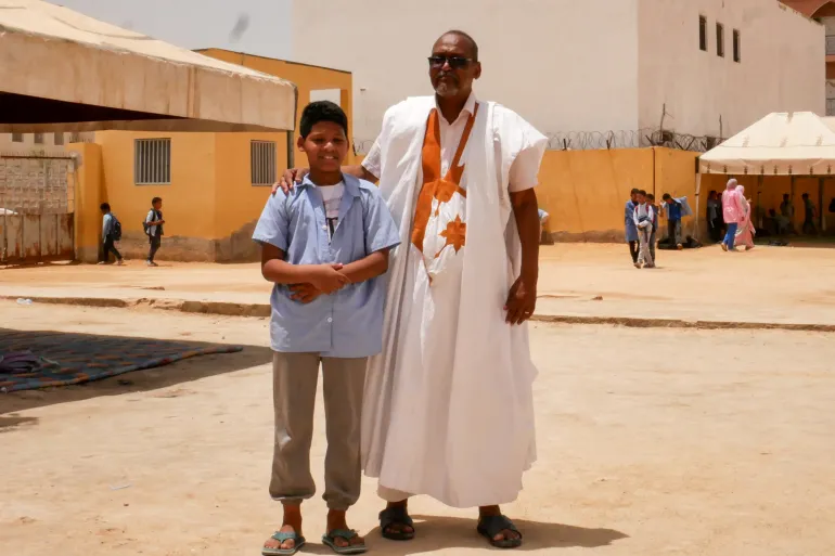Rais and his son, Ely Cheikh, pose in the Abdellahi Ould Nouegued public school after classes in Noaukchott