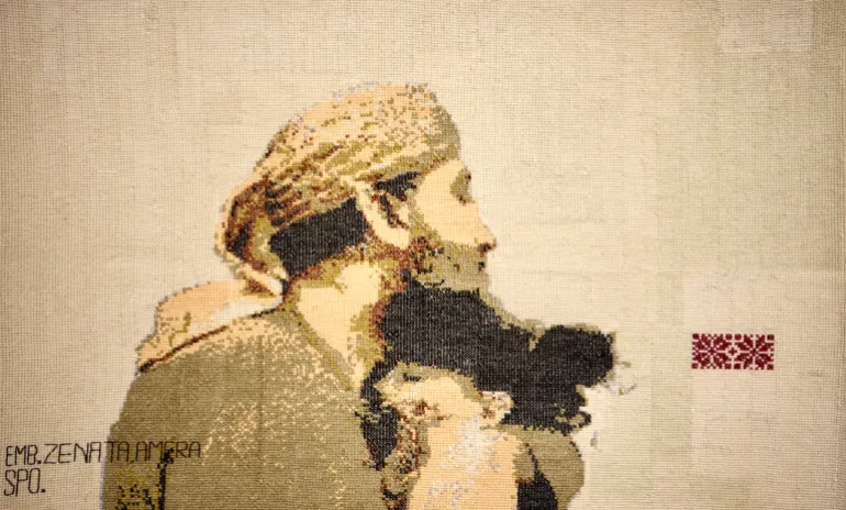 An embroidery of Khalid Nabhan hugging his dead granddaughter