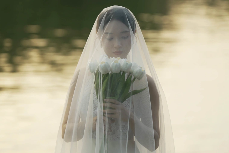 A bride poses during a wedding photo shoot in the Forbidden City in Beijing in March 2025.