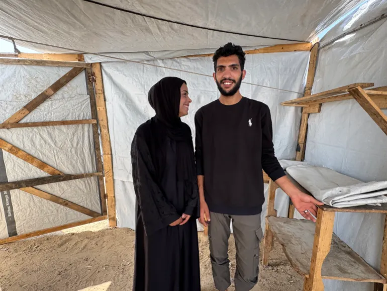 The couple, Mohammad Ahliwat and Saja Al-Masri, who are set to get married in a few days, are preparing for their wedding inside a tent in a displacement camp [Al Jazeera]