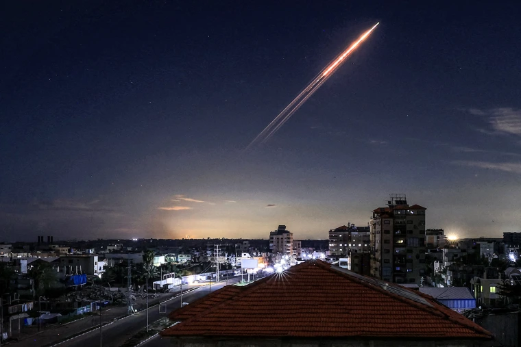 Image: A missile launched from Iran in the sky, viewed from the Bureij camp for Palestinian refugees in the central Gaza Strip
