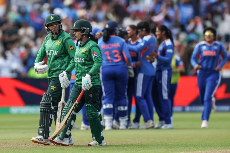 Pakistan players (L) walk off as India (behind) celebrate their victory at the end of the ICC Women's T20 cricket World Cup 2026 Group A stage, Match 6 match between the India and Pakistan at Edgbaston cricket ground in Birmingham, central England on June 14, 2026. (Photo by Darren Staples / AFP)