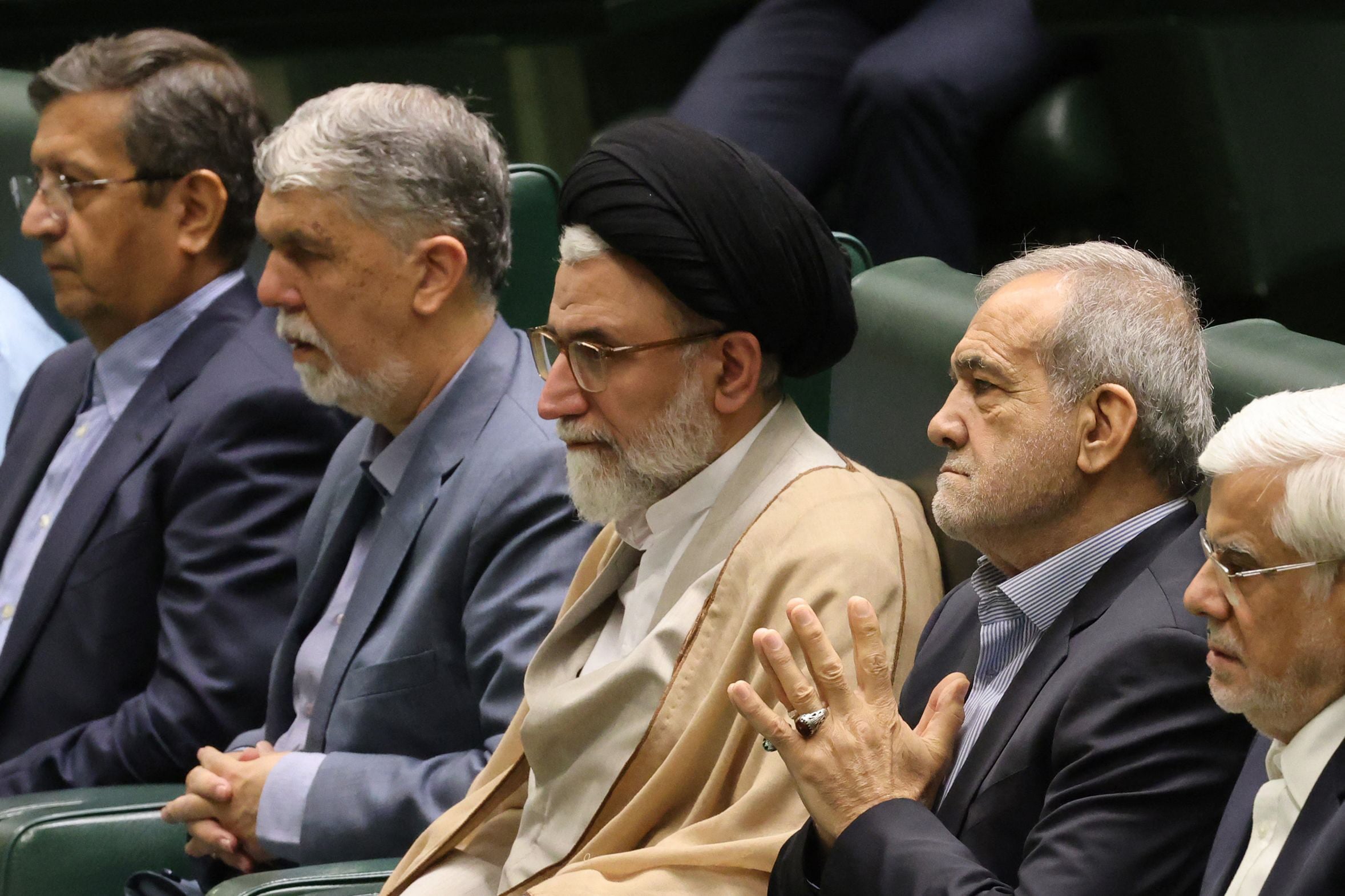 Iran's Minister of Intelligence Esmail Khatib sits with Iran's President Masoud Pezeshkian before a speech to defend his cabinet selection to members of parliament in the capital Tehran on August 17, 2024. PHOTO FILE: AFP