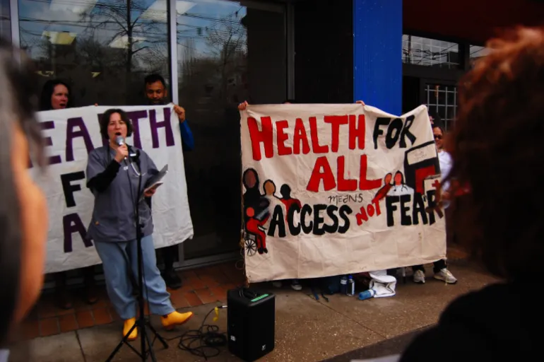 Activists protest against cuts to refugee health care in Canada