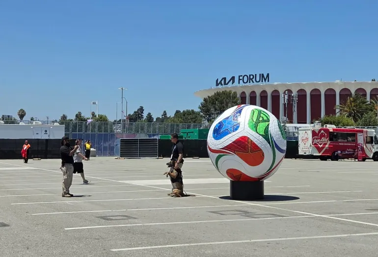 Dog and officer standing next to giant ball