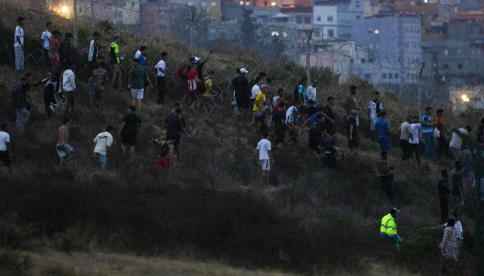 People gather on a hilltop near Bab Sebta on the Morocco-Spain border, near Spain´s enclave of Ceuta and the Moroccan town of Fnideq on July 30, 2026. — AFP