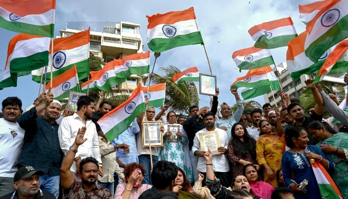 Protesters wave the Indian national flags during a demonstration in Mumbai on July 25, 2026. — AFP