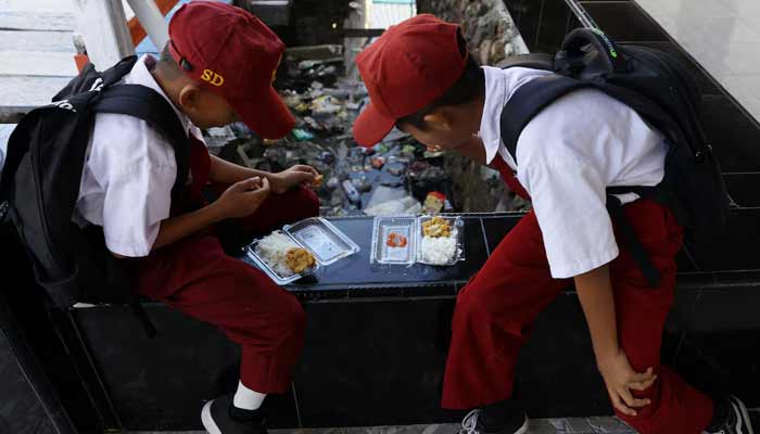 Students eat from plastic containers at a school in the fishing village of Torosiaje, Gorontalo province, Indonesia, July 27, 2026.— Reuters