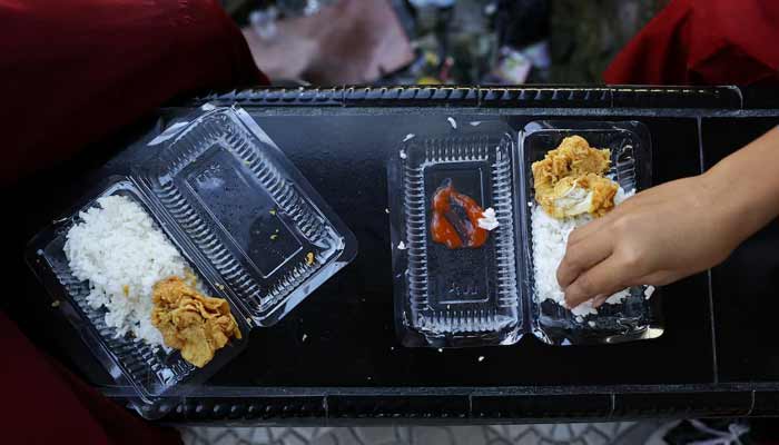 Students eat from plastic containers at a school in the fishing village of Torosiaje, Gorontalo province, Indonesia, July 27, 2026.— Reuters