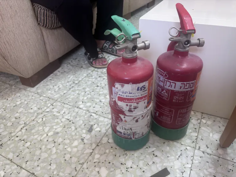 Fire extinguishers that Sandra and Roland bought to extinguish fires they say are lit by Israeli settlers [Al Jazeera]