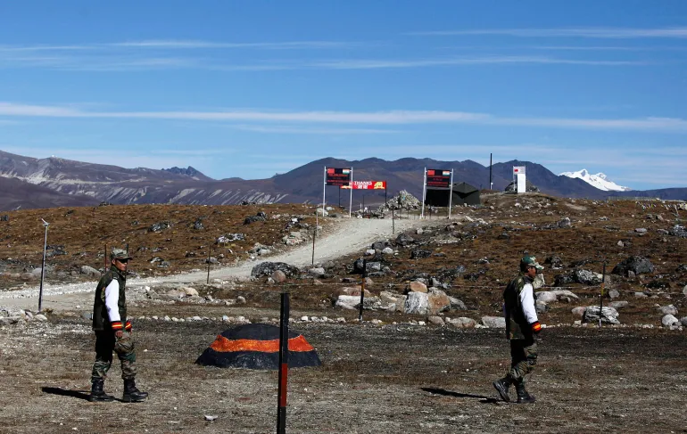 Indian army soldiers walk along the Line of Control at the Indo-China border in Bumla at an altitude of 4,780 metres (15,700 feet) above sea level in Arunachal Pradesh, India, on October 21, 2012