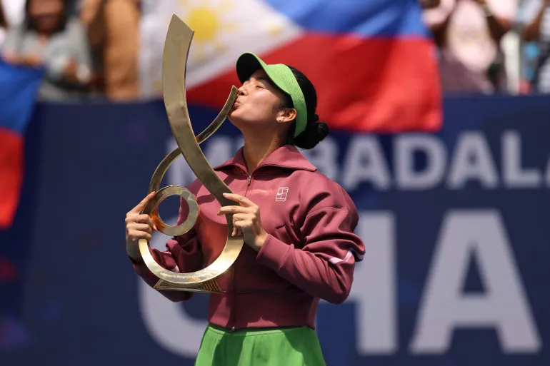 Alexandra Eala (PHI) kisses the championship trophy during the trophy ceremony after her match against Jessica Pegula (USA) (not pictured) in the women's singles final of the 2026 Mubadala DC Open
