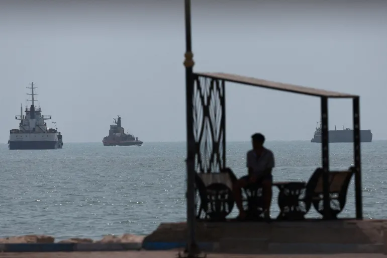 Vessels in the Strait of Hormuz are visible near the beach of Bandar Abbas, Iran, August 28, 2026. [Majid Asgaripour/WANA via Reuters]