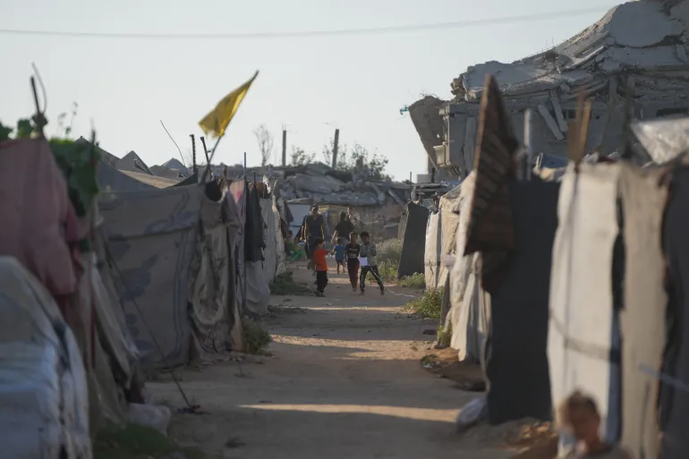 Children play in a tent camp for displaced Palestinians in Nuseirat, central Gaza Strip Friday, July 31, 2026. (AP Photo/Abdel Kareem Hana)