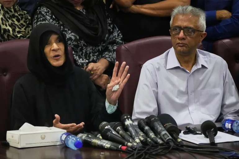 Former Pakistani Prime Minister Imran Khan's sister Uzma Khan, left, speaks as Khan's personal physician Faisal Sultan watches during a press conference in Islamabad, Pakistan
