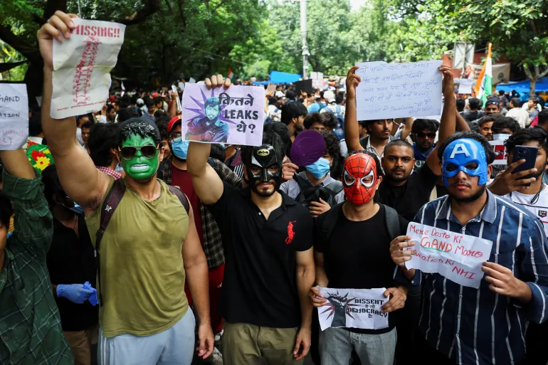 Cockroach Janta Party supporters in masks hold placards and chant slogans during protests over examination paper leaks, at Jantar Mantar in New Delhi, India, July 22, 2026