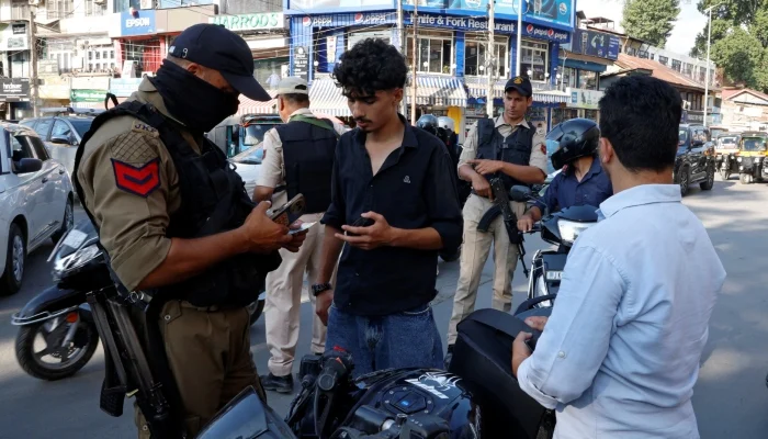 A police officer checks the identity papers of a motorist in a street ahead of Indias Independence Day celebrations in Srinagar, Indian Illegally Occupied Jammu and Kashmir, August 12, 2026. — Reuters