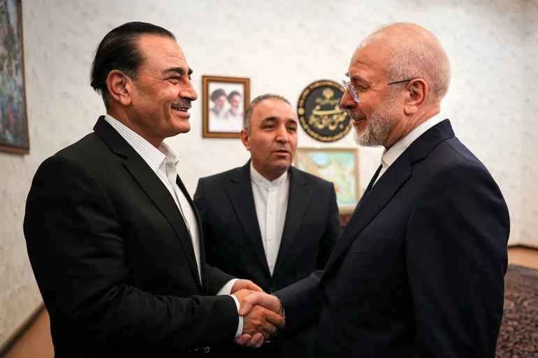 This handout picture provided by Iran’s parliament speaker’s office shows Speaker Mohammad Bagher Ghalibaf, right, receiving Pakistan’s army chief Field Marshall Asim Munir in Tehran on August 24, 2026 [AFP]
