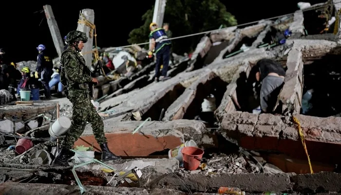 A member of the military walks as rescuers work amidst the debris at the Torres de Limonar building in the aftermath of an earthquake, in Cali, Colombia, August 11, 2026. — Reuters