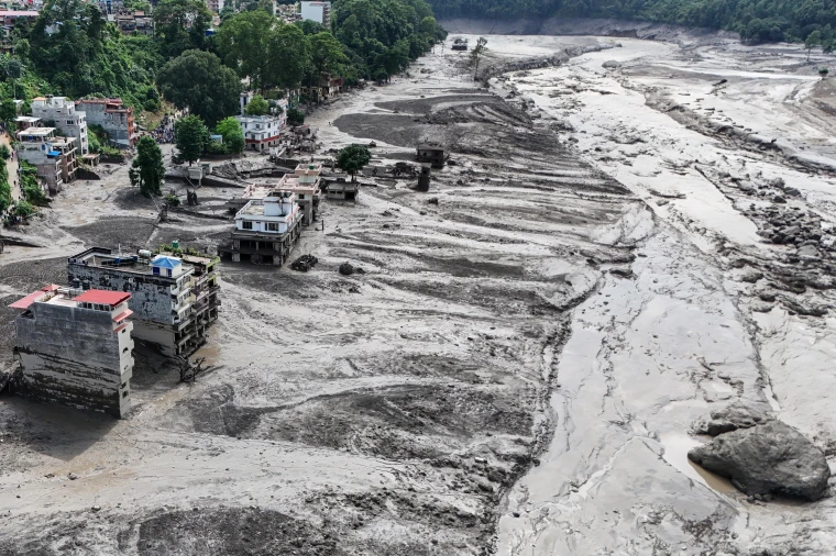 An aerial view shows buildings and infrastructure damaged by floods.