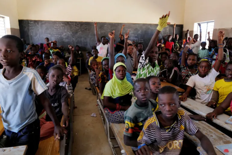 Schoolchildren displaced by armed group attacks attend a class in Dori, Burkina Faso. The impact of insecurity continues to be felt across the Sahel as armed groups exploit regional security gaps [Zohra Bensemra/Reuters]