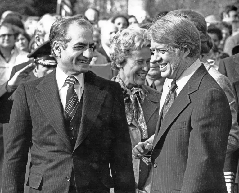 View of the Shah of Iran Mohammed Reza Pahlavi (left) and US President Jimmy Carter as they share a smile during a State Visit on the South Lawn of the White House, Washington DC, November 15, 1977.
