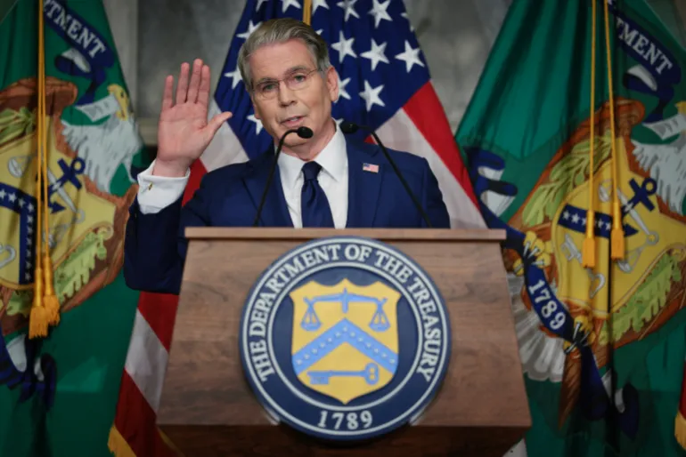 WASHINGTON, DC - AUGUST 24: U.S. Treasury Secretary Scott Bessent waves goodbye to reporters after announcing a new set of sanctions against Iran, describing them as "an economic D-Day", in the Cash Room at the Treasury Department on August 24, 2026 in Washington, DC. Bessent threatened Iran in an opinion piece in the Financial Times on Sunday with "the single greatest financial offensive ever", almost six months after the United States and Israel launched a war against Iran in February. Chip Somodevilla/Getty Images/AFP (Photo by CHIP SOMODEVILLA / GETTY IMAGES NORTH AMERICA / Getty Images via AFP)