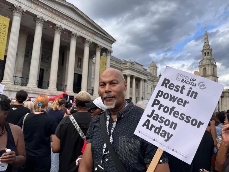 Social worker Paul Vincent holds a ‘Rest in Power’ sign at a vigil for Jason Arday in London