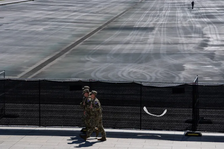 Members of the National Guard walk near fences at the drained Lincoln Memorial Reflecting Pool, following renovations and Independence Day celebrations, in Washington, D.C., U.S., July 30, 2026. REUTERS/Nathan Howard
