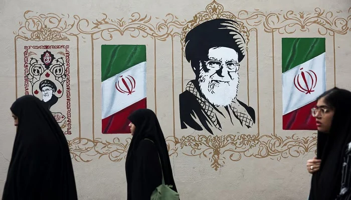 People walk by a mural depicting Irans late Supreme Leader Ayatollah Ali Khamenei on a street in Tehran, Iran, August 13, 2026. — Reuters