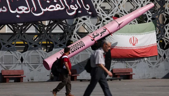 People walk next to a symbolic mockup of an Iranian missile and an Iranian flag at Imam Hussein Square in Tehran, Iran, July 12, 2026. — Reuters