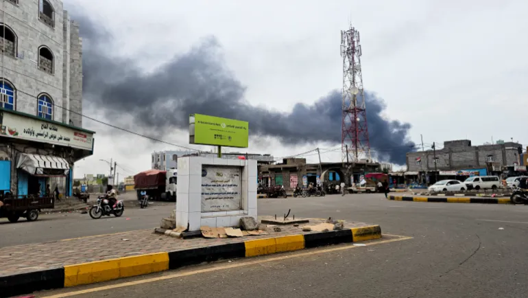 Smoke rises from the site of Houthi missile and drone strikes on the Red Sea port city of al-Makha (Mocha), Yemen [Reuters]