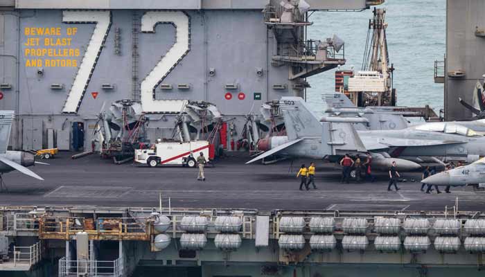 Crew members walk on the flight deck of US nuclear-powered aircraft carrier USS Abraham Lincoln (CVN-72) as it heads towards Laem Chabang Port, near the city of Pattaya on September 2, 2026.— AFP