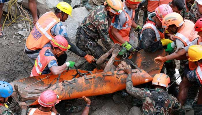 A survivor is carried by members of a search and rescue team after they rescued two people alive who had been trapped inside a tunnel at the Trishuli-3A Hydropower Project following devastating floods and mudslides that struck the Bhotekoshi River in Rasuwa, Nepal, on September 4, 2026.— Reuters
